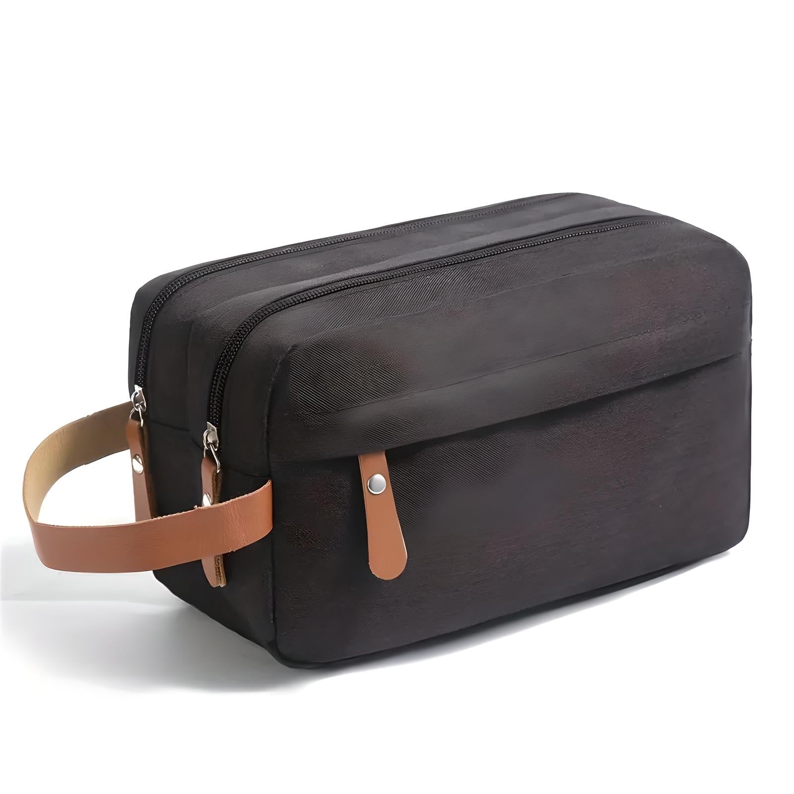Borsa da toilette nera con doppia cerniera, manico in pelle marrone, design elegante e spazioso, ideale per viaggi e organizzazione accessori.