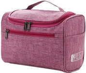Borsa da toilette rosa con manico, tasca frontale con zip, design compatto. Ideale per viaggi, organizzazione accessori bagno.