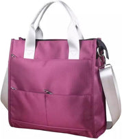 Borsa tote rosa con manici bianchi e tracolla regolabile, tasche frontali con zip, design elegante e funzionale, perfetta per l'uso quotidiano.
