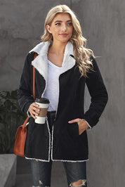 Donna con cappotto nero foderato in pelliccia sintetica, maglietta bianca, jeans strappati, borsa marrone e caffè da asporto. Moda casual autunnale.