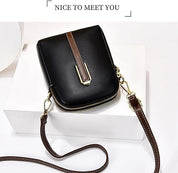 Borsa a tracolla nera in pelle con cerniera dorata e cinturino marrone, design elegante e compatto, ideale per moda femminile e accessori.