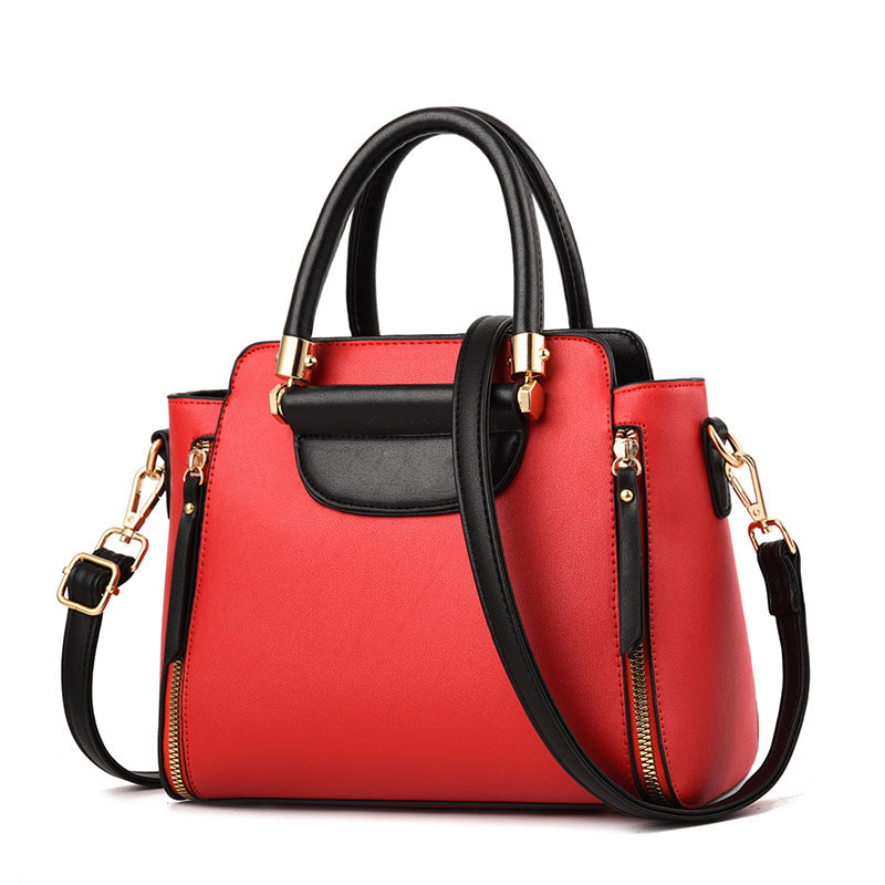 Borsa a mano donna in pelle rossa con dettagli neri, tracolla regolabile, chiusura zip dorata. Elegante e moderna, perfetta per ogni occasione.