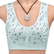 Reggiseno sportivo verde chiaro con stampa floreale, chiusura frontale a bottoni, collana con ciondolo bianco. Intimo donna comodo ed elegante.