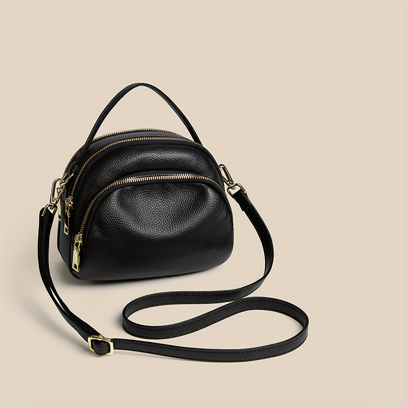 Elegante borsa a tracolla in pelle nera con doppia zip e dettagli dorati, perfetta per moda donna e accessori di lusso.