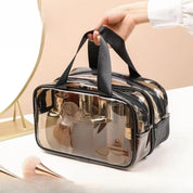 Borsa trasparente da viaggio con manici neri, ideale per cosmetici e accessori. Design elegante e pratico, perfetto per organizzare il beauty case.