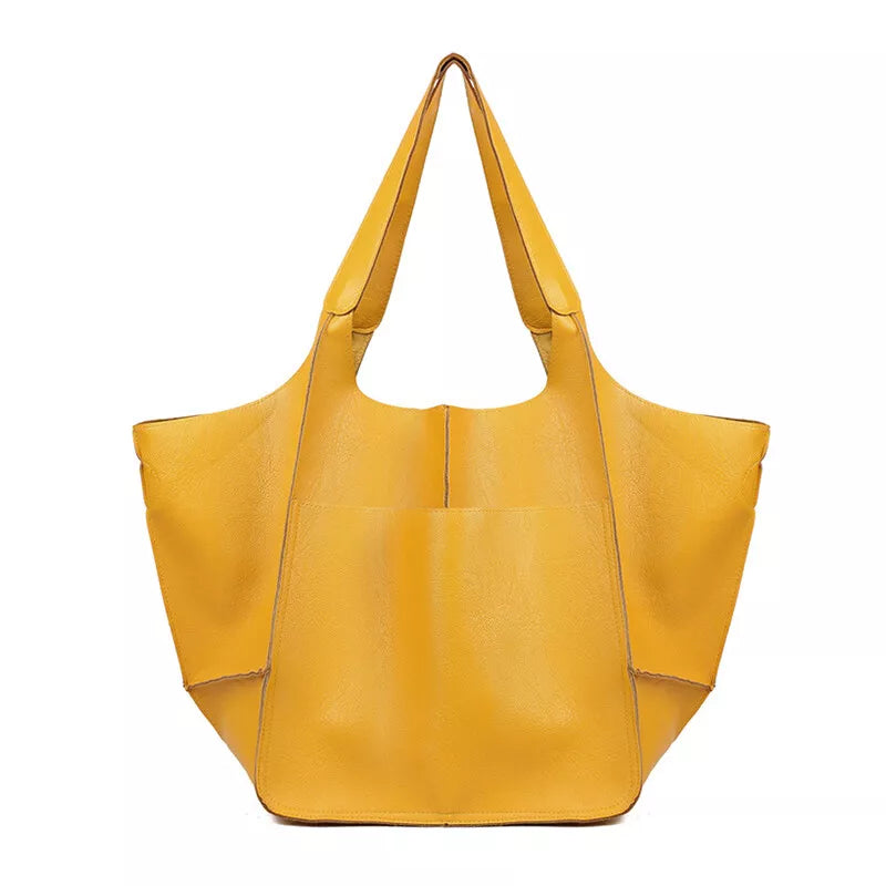 Borsa tote gialla in pelle sintetica, design moderno e spazioso, ideale per shopping e uso quotidiano. Accessorio moda donna elegante e pratico.
