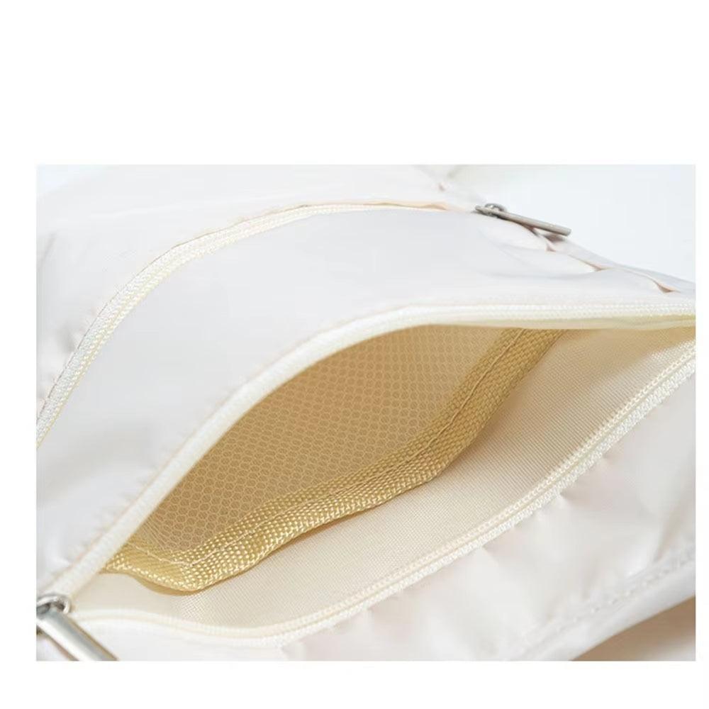 Zaino bianco in tessuto impermeabile con cerniera aperta, interno beige. Design elegante e pratico, ideale per scuola o viaggio.