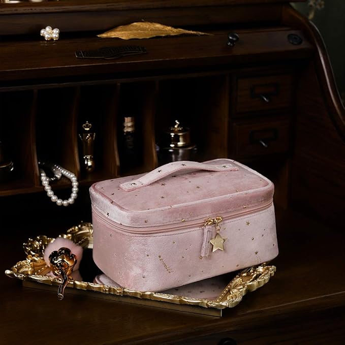 Astuccio cosmetico rosa in velluto con stelle dorate, su vassoio decorativo. Accessori eleganti sullo sfondo. Perfetto per trucco e gioielli.