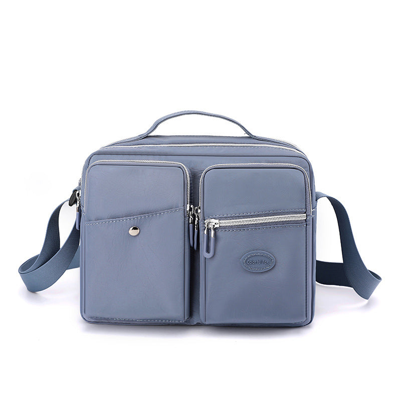 Borsa a tracolla in pelle blu con tasche multiple e cerniere, design elegante e funzionale, ideale per uomo e donna, perfetta per uso quotidiano.