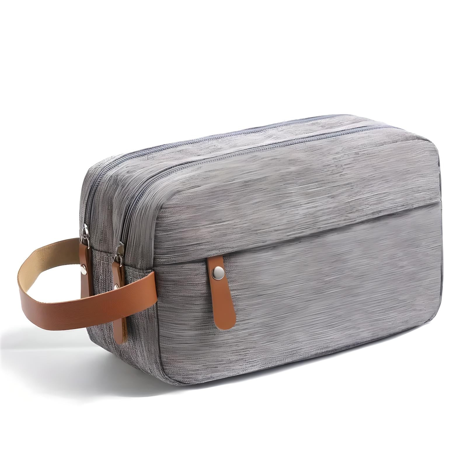 Borsa da toilette grigia con manico in pelle marrone, design moderno, chiusura a zip, ideale per viaggi, accessori bagno, organizer compatto.
