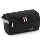 Borsa da viaggio nera con cerniera, manico grigio, tasca frontale, ideale per organizzare accessori da toilette. Design compatto e pratico.