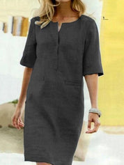 Abito donna elegante grigio scuro, maniche corte, scollo a V, vestibilità comoda. Ideale per occasioni formali e casual. Taglia S.