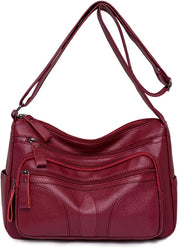 Borsa a tracolla in pelle rossa con tasche multiple e cerniere, design elegante e pratico, ideale per donna. Accessorio moda versatile e capiente.