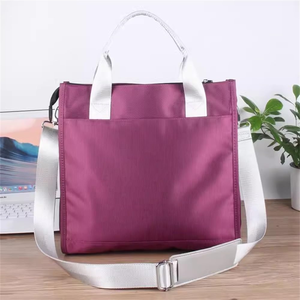 Borsa a tracolla viola con manici bianchi, design moderno, su scrivania in legno accanto a laptop e pianta verde. Accessorio moda elegante.