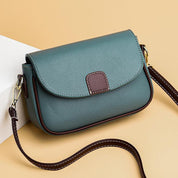 Borsa a tracolla in pelle verde con patta frontale marrone, design elegante e moderno, ideale per moda donna, accessori di tendenza.