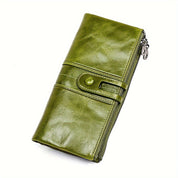 Portafoglio donna in pelle verde, design elegante con chiusura a bottone e cerniera. Accessorio moda, alta qualità, stile moderno.