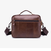 Borsa a tracolla in pelle marrone per laptop, con manico superiore, tasca frontale con zip e tracolla regolabile. Elegante e funzionale per lavoro.