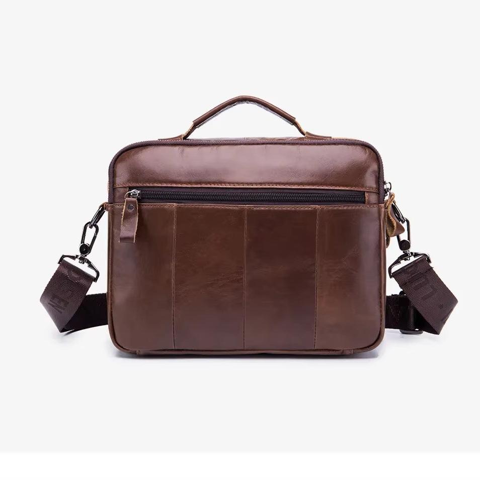Borsa a tracolla in pelle marrone per laptop, con manico superiore, tasca frontale con zip e tracolla regolabile. Elegante e funzionale per lavoro.