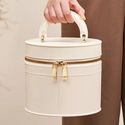 Borsa a mano cilindrica bianca in pelle con cerniera dorata, design elegante e moderno, ideale per moda femminile e accessori di lusso.