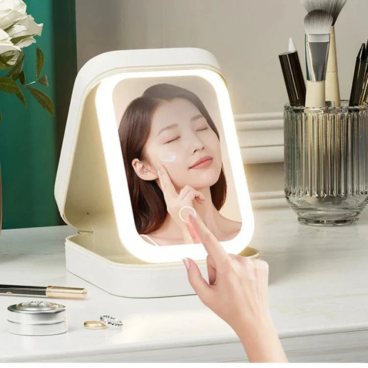 Specchio cosmetico LED con touch screen, illuminazione regolabile, design portatile, ideale per trucco e skincare, posizionato su tavolo da trucco.
