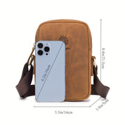 Borsa a tracolla in pelle marrone con smartphone grigio, dimensioni 14x21,5x5 cm. Design elegante, ideale per accessori moda e tecnologia.