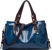 Borsa a mano in pelle blu lucida con manici marroni, dettagli in metallo dorato, design elegante e spazioso, perfetta per moda femminile.