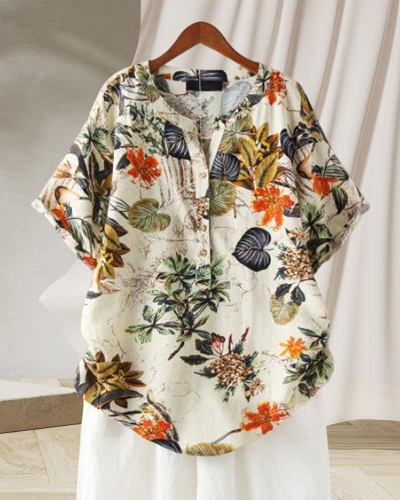 Camicia donna floreale in cotone, maniche corte, sfondo bianco, motivi tropicali colorati, perfetta per estate, moda casual, abbigliamento leggero.