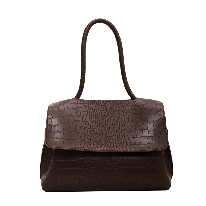 Borsa a mano in pelle marrone con texture coccodrillo, design elegante e manico lungo. Accessorio moda donna, ideale per ogni occasione.