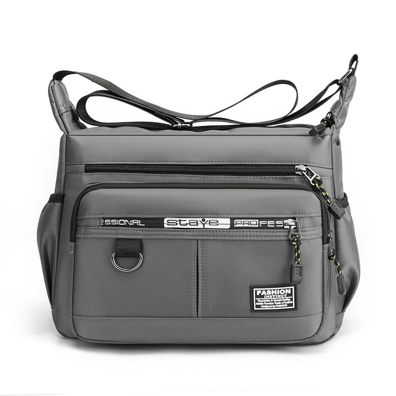 Borsa a tracolla grigia unisex, design moderno, tasche multiple con zip, ideale per viaggio e lavoro. Materiale resistente e impermeabile.