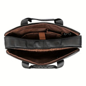 Borsa porta computer in pelle nera, vista dall'alto, con scomparti interni marroni. Elegante e funzionale, ideale per lavoro e viaggio.