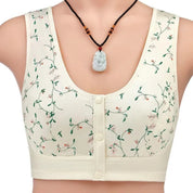 Reggiseno sportivo bianco con stampa floreale verde, chiusura frontale a bottoni, indossato con collana pendente. Intimo donna comodo ed elegante.