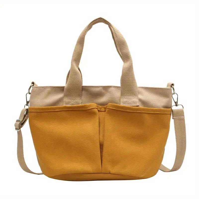 Borsa a tracolla in tela gialla con manici beige, tasche frontali e tracolla regolabile. Design casual, ideale per uso quotidiano.
