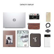 Laptop Dell argento con fotocamera, smartphone, riviste, custodia in pelle, orologio, power bank e accessori. Display capacità.