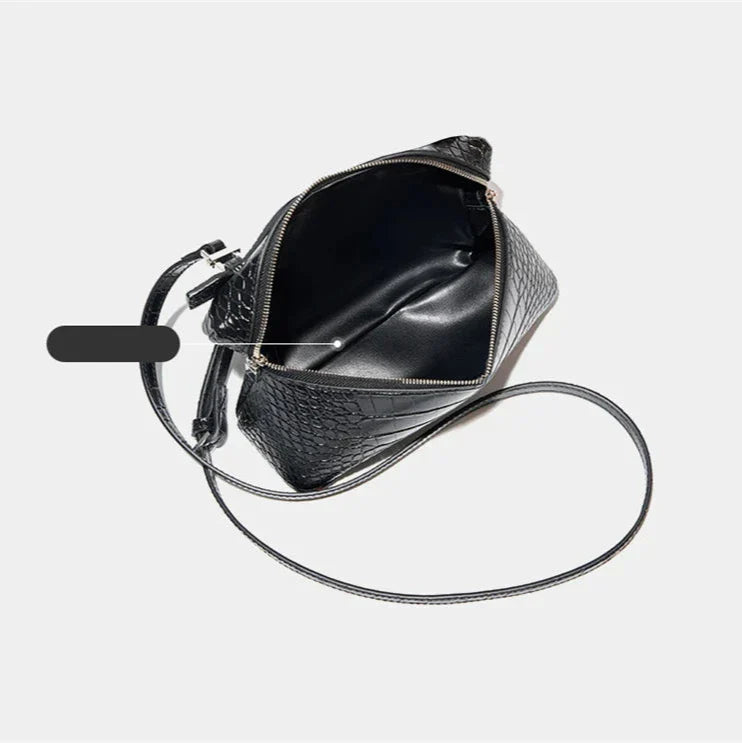 Borsa a tracolla nera in pelle con texture coccodrillo, apertura con zip, interno spazioso, design elegante e moderno, accessorio moda donna.