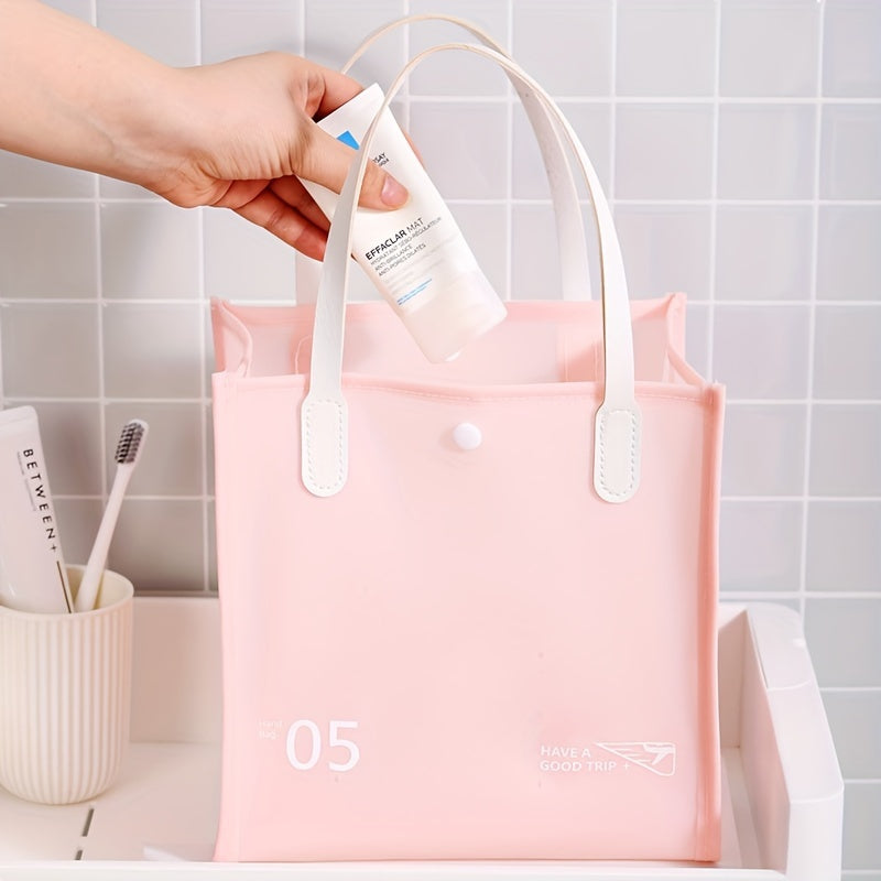 Borsa da viaggio rosa in PVC con manici bianchi, ideale per cosmetici. Design elegante, impermeabile, perfetta per organizzare prodotti da bagno.