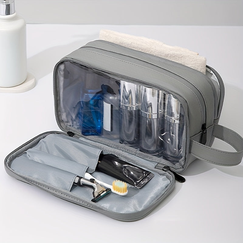 Borsa da toilette grigia con scomparti trasparenti, contenente flaconi da viaggio, rasoio e spazzolino. Ideale per organizzare accessori da bagno.