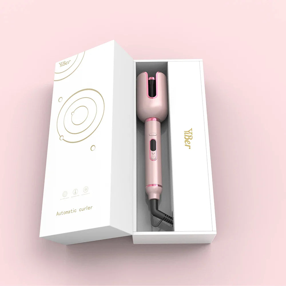 Arricciacapelli automatico rosa in confezione elegante, design moderno, ideale per styling capelli professionale. Accessorio bellezza innovativo.