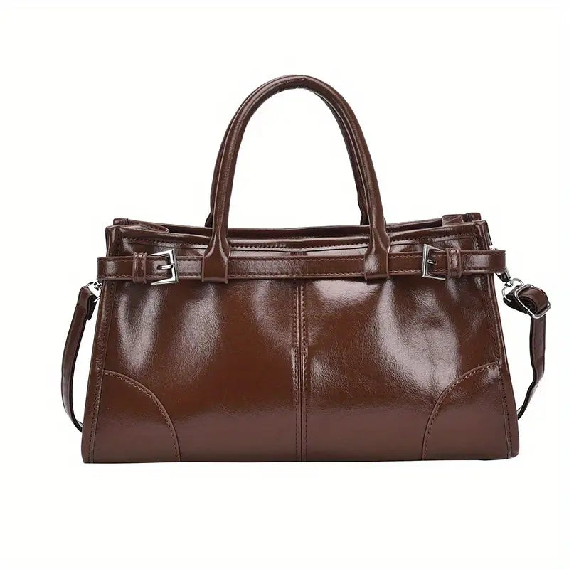 Borsa a mano in pelle marrone lucida con doppio manico e tracolla regolabile, design elegante e moderno, perfetta per l'uso quotidiano e occasioni speciali.