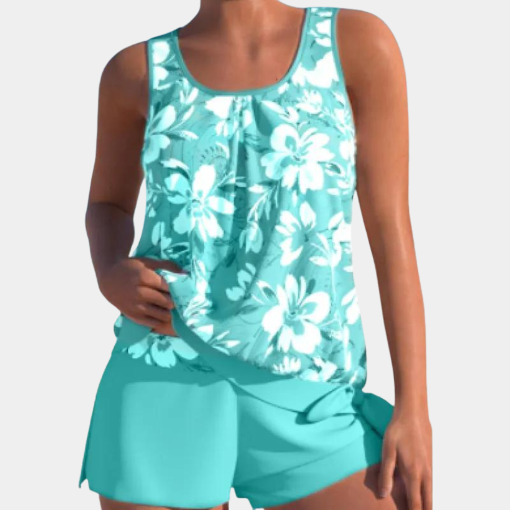 Top tankini donna floreale azzurro, senza maniche, con pantaloncini coordinati. Costume da bagno estivo, moda mare, abbigliamento donna.