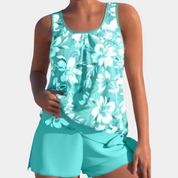 Top tankini donna floreale azzurro, senza maniche, con pantaloncini coordinati. Costume da bagno estivo, moda mare, abbigliamento donna.