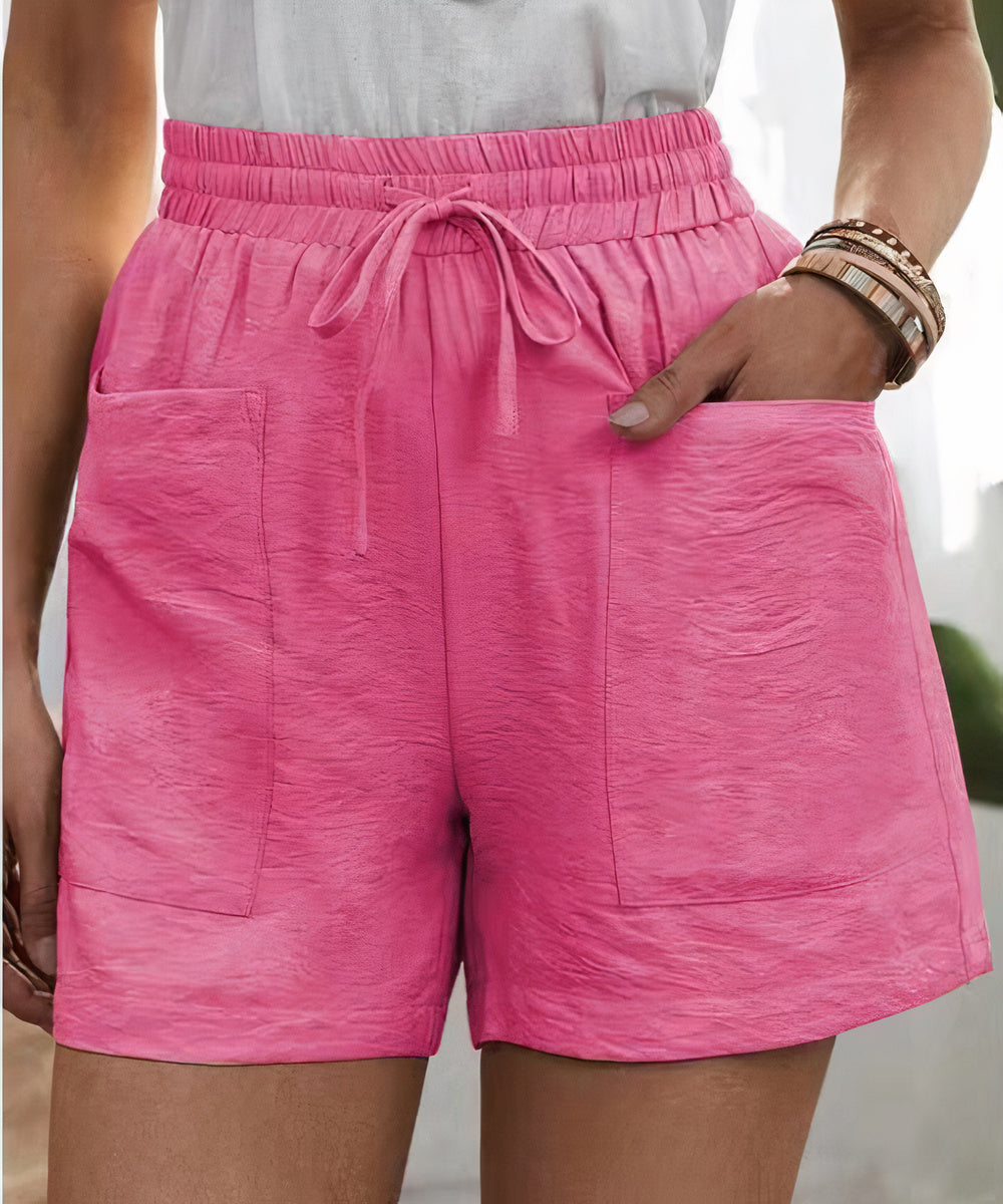 Pantaloncini rosa da donna con tasche, elastico in vita e laccio, tessuto leggero. Ideali per l'estate, moda casual, abbigliamento comodo.
