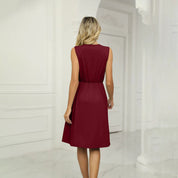 Abito rosso bordeaux senza maniche, donna di spalle in ambiente elegante. Vestito estivo elegante, moda femminile, abbigliamento casual chic.