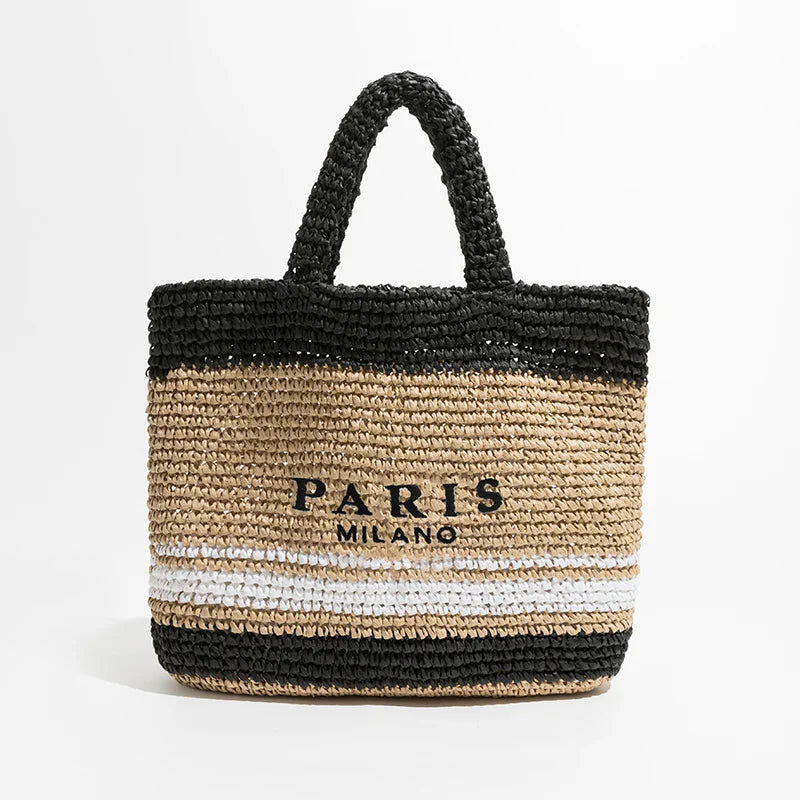 Borsa in paglia intrecciata beige e nera con manici, scritta "Paris Milano", design elegante, perfetta per l'estate e lo shopping.