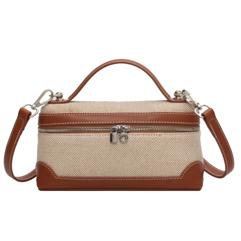 Borsa a tracolla in pelle marrone e tessuto beige, design elegante con zip frontale e manico superiore. Accessorio moda donna, stile casual chic.