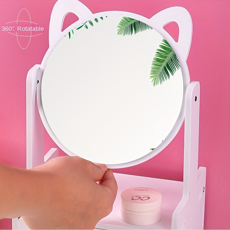 Specchio da tavolo girevole a 360°, design orecchie di gatto, colore bianco, con foglie tropicali riflettenti, su sfondo rosa. Accessorio decorativo.