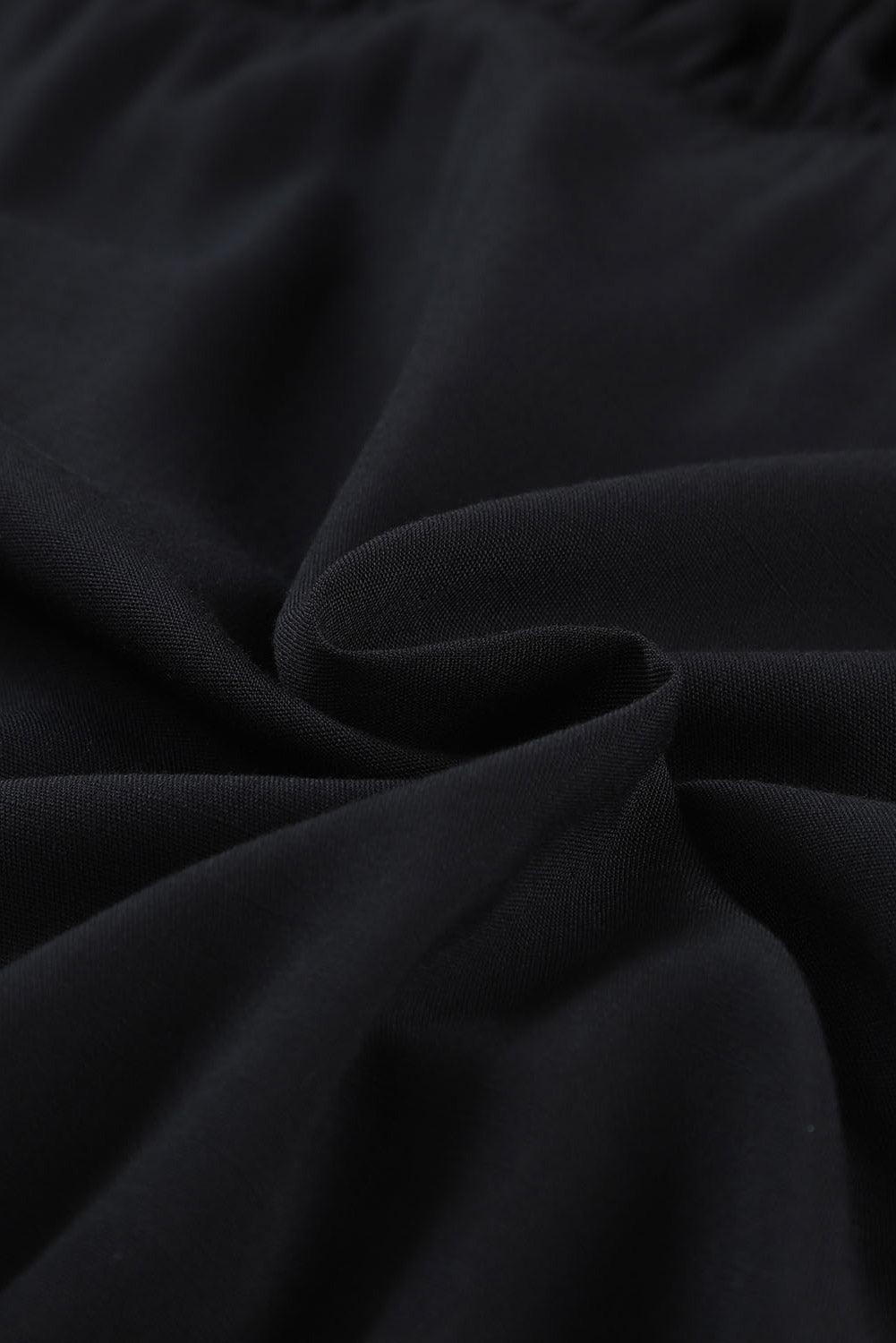 Tessuto nero in cotone morbido, dettaglio texture pieghettata, ideale per abbigliamento casual, moda donna, alta qualità, comfort.