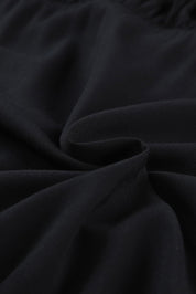 Tessuto nero in cotone morbido, dettaglio texture pieghettata, ideale per abbigliamento casual, moda donna, alta qualità, comfort.