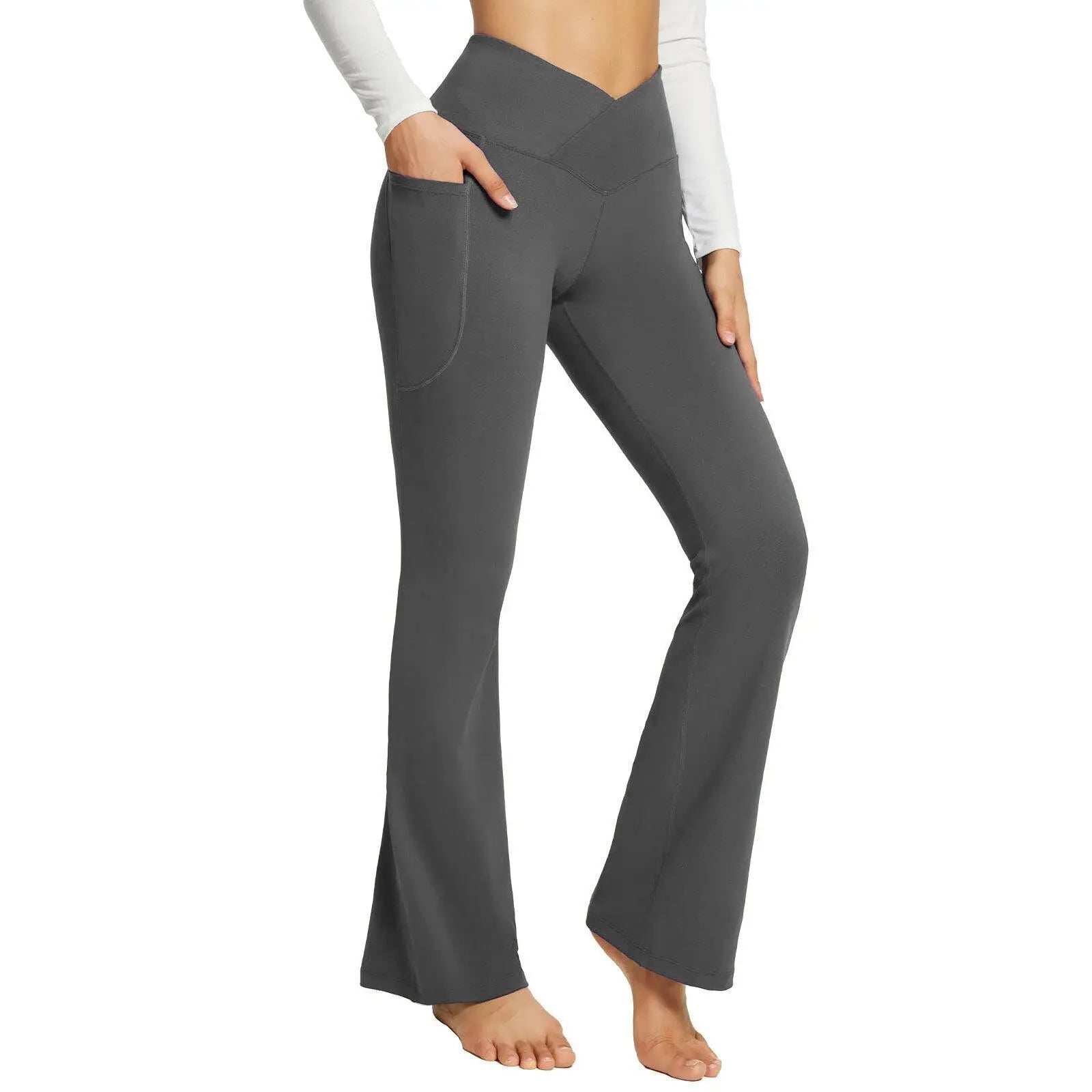Pantaloni yoga a vita alta grigi con tasche, design a campana, indossati da una donna. Abbigliamento sportivo comodo ed elegante.