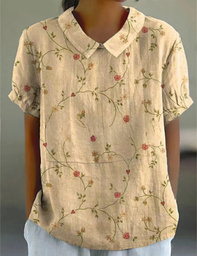 Camicia donna beige con colletto, maniche corte e stampa floreale vintage. Elegante e casual, perfetta per moda estiva e abbigliamento quotidiano.