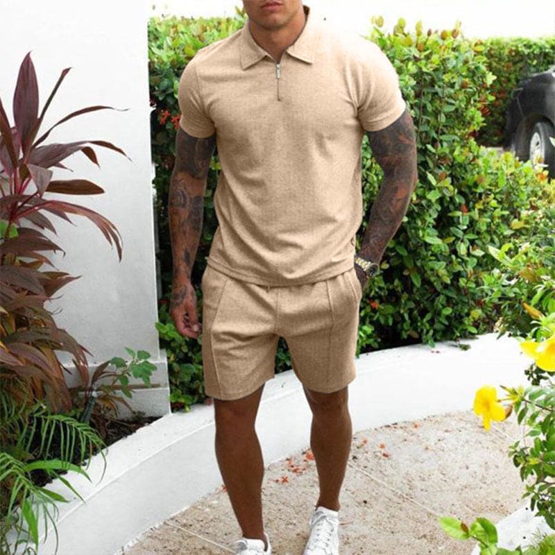 Uomo in completo estivo beige, polo e pantaloncini, in giardino. Moda casual maschile, abbigliamento estivo, stile elegante.